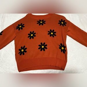 Sweater cardigan orange with black and yellow flowers for the fall and winter.